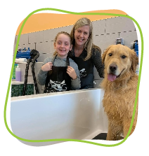 Girl helps wash a dog